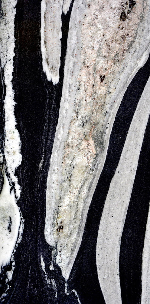 Abstract image of black, white, and gray swirling lines resembling marble or geological formations.