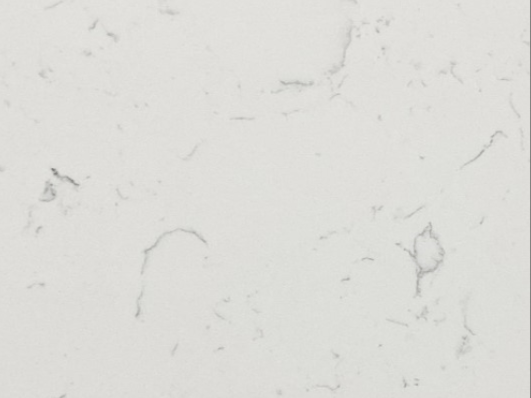 White marble surface with light grey veining and subtle dark specks.