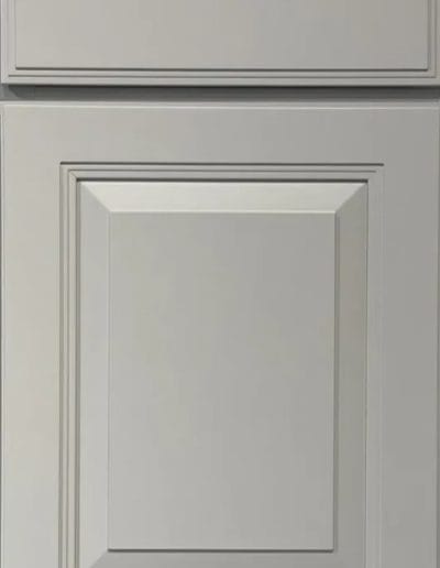 Gray shaker-style cabinet door with rectangular raised panels and simple, clean lines.