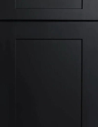 Matte black cabinet door with a rectangular panel design and simple, modern lines.