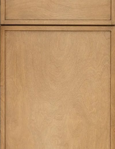 Light-colored wooden cabinet door with a rectangular panel design and a horizontal drawer above.