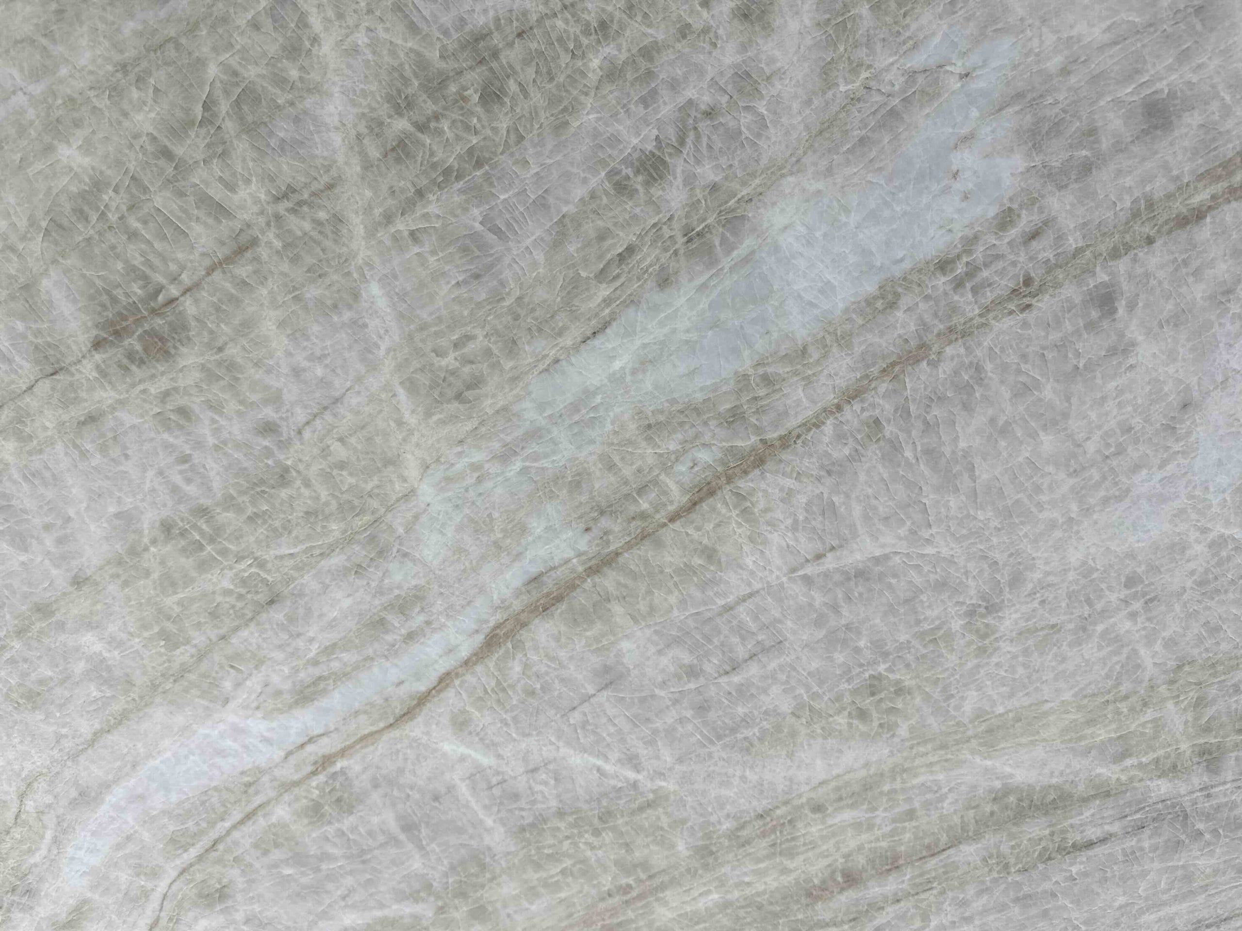 Taj Mahal Lux Quartzite Light gray marble surface with subtle veining and natural textured patterns throughout.