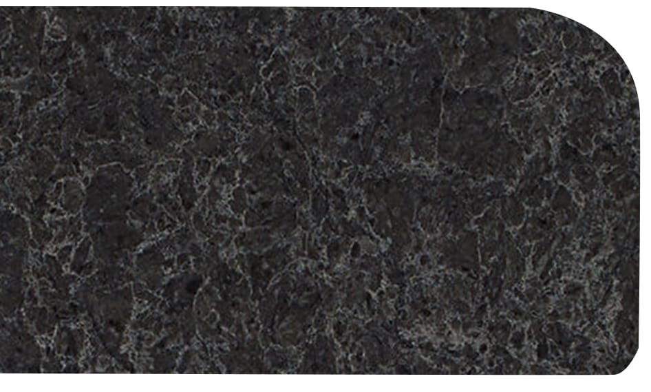 1.4round Close-up of a dark, textured granite surface with white and gray veining and a rounded corner.