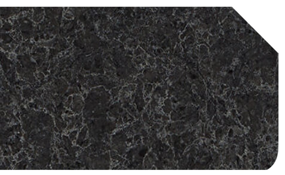 1_2-bevel Close-up of a dark gray and black stone countertop sample with a beveled corner and subtle veining.